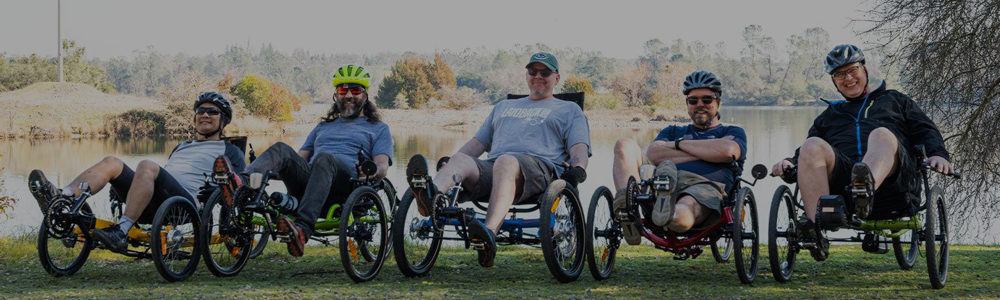 Laid Back Cycles staff lined up sitting on their recumbent trikes smiling