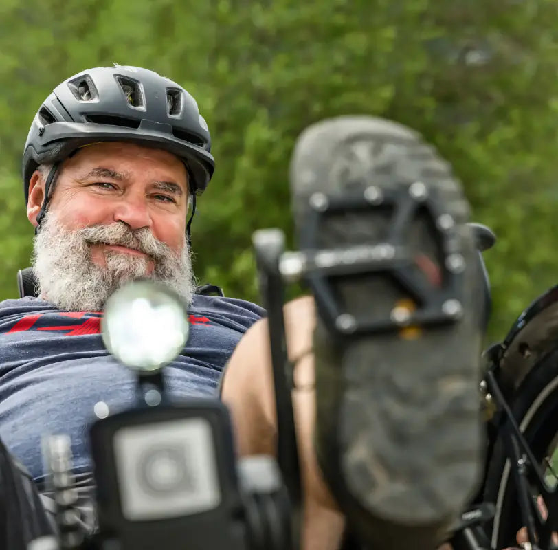 Rider on an AZUB T-Tris AR recumbent trike outdoors