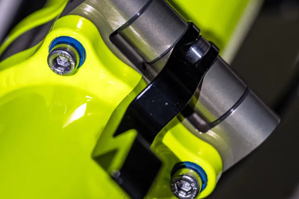 Front suspension shock and titanium pivot hardware on the AZUB Ti-FLY 20 recumbent trike