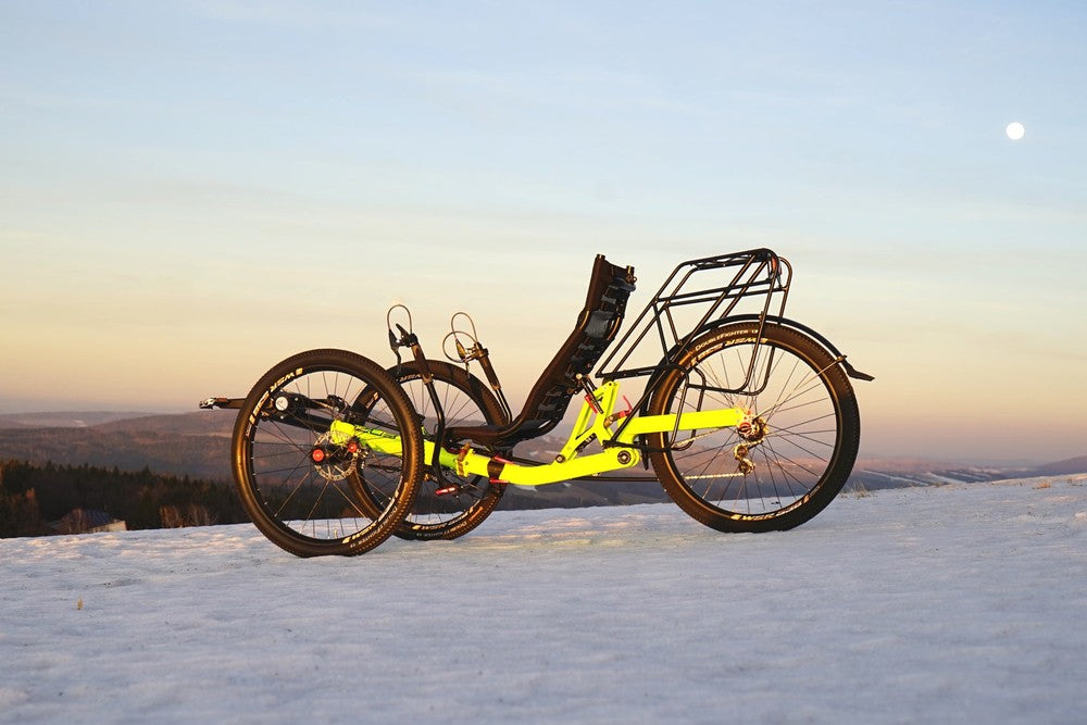 AZUB TRIcon GR recumbent trike side profile with 26-inch wheels on a snowy ridge