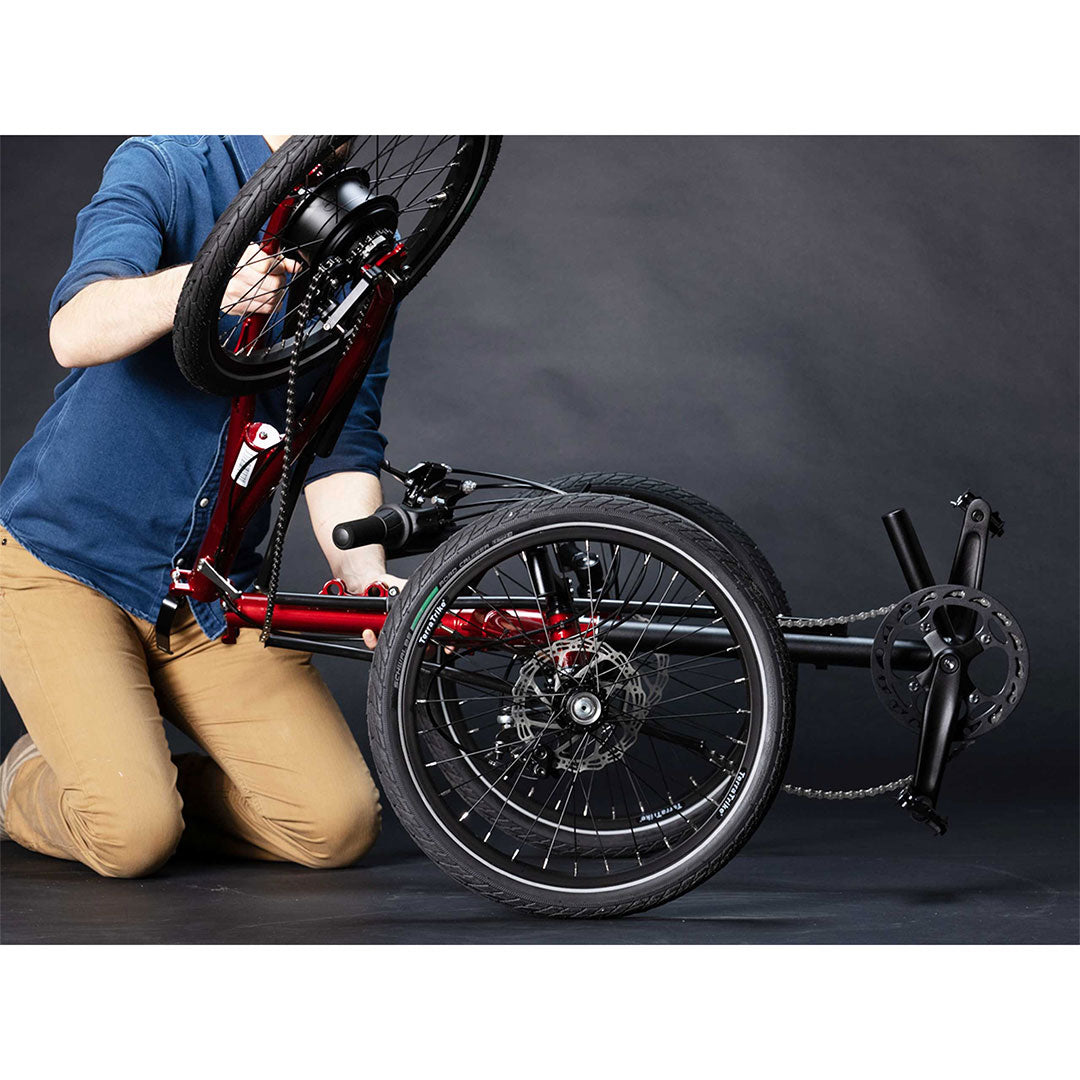 TerraTrike Traveler non drive chain side trike is being folded by person