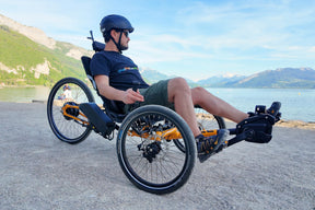 Rider on an ICE Adventure 26 PERS chainless trike by a lake