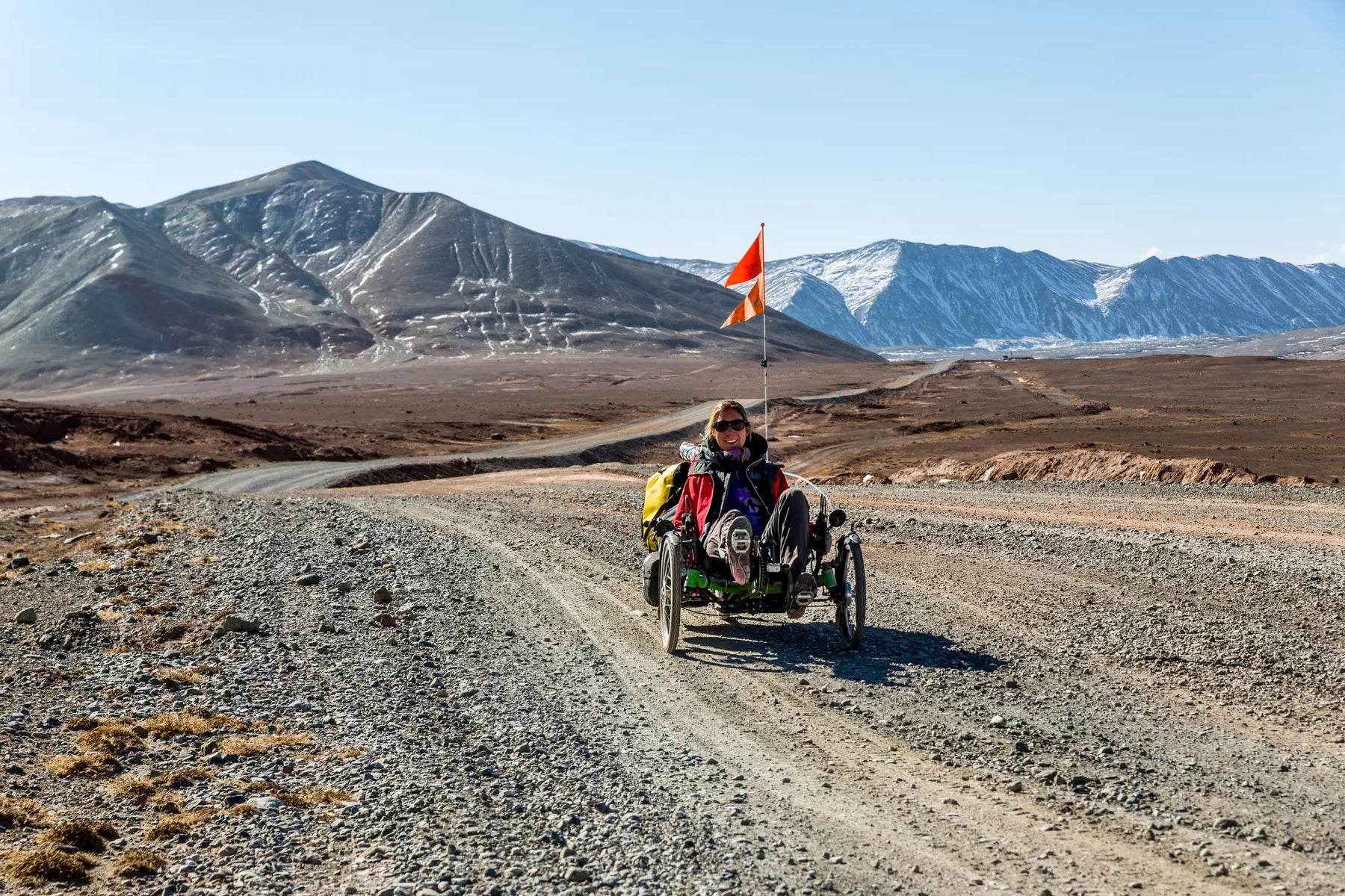 Rider on an AZUB TRIcon 20 recumbent trike touring a mountain road