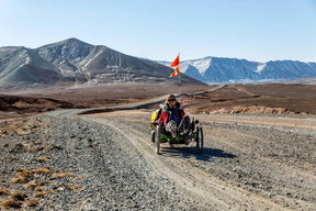 Rider on an AZUB TRIcon 20 recumbent trike touring a mountain road