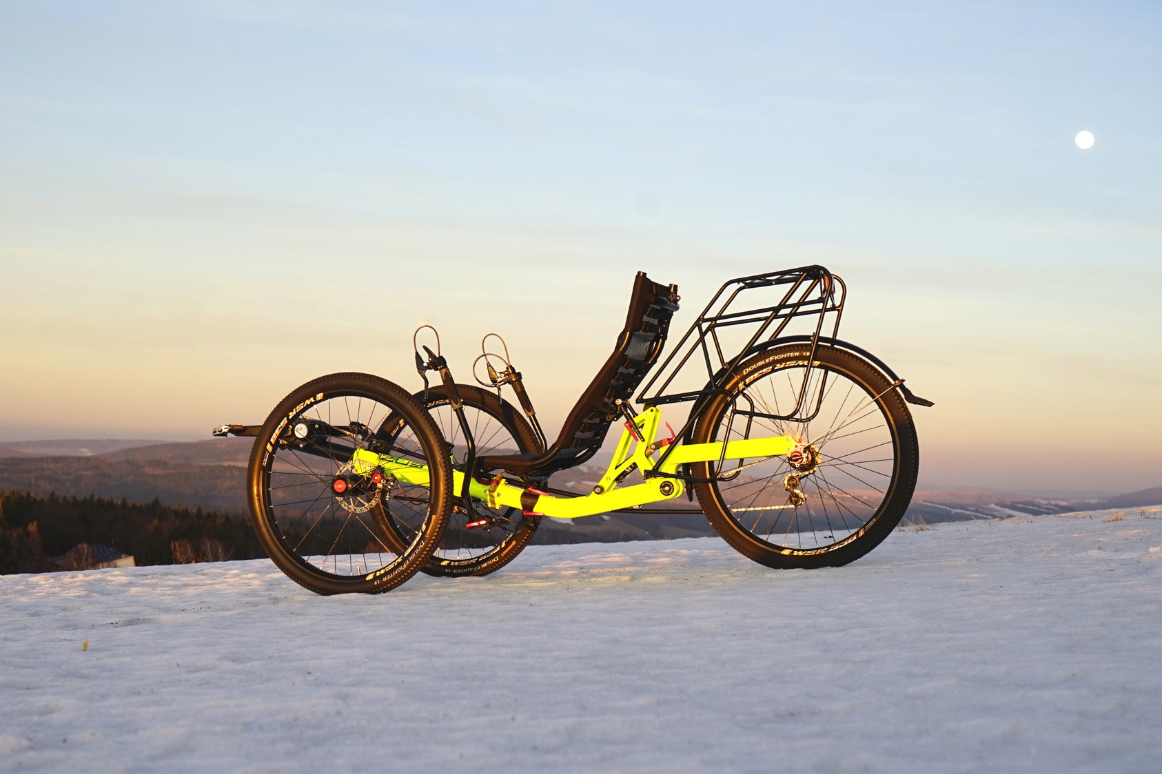AZUB TRIcon GR recumbent trike side profile with three 26-inch wheels on a snowy ridge