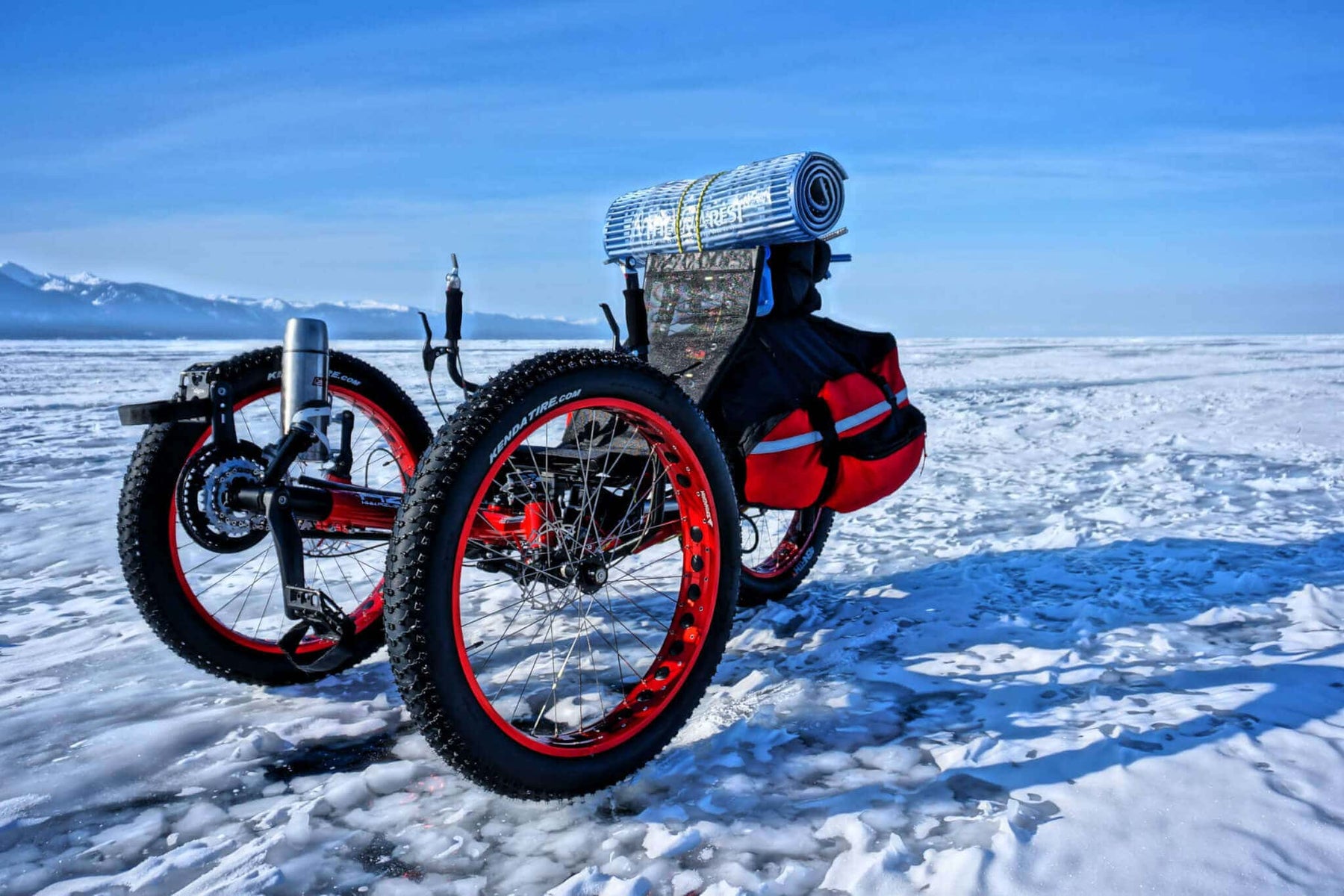 AZUB FAT recumbent trike with red anodized rims parked on the frozen Lake Baikal
