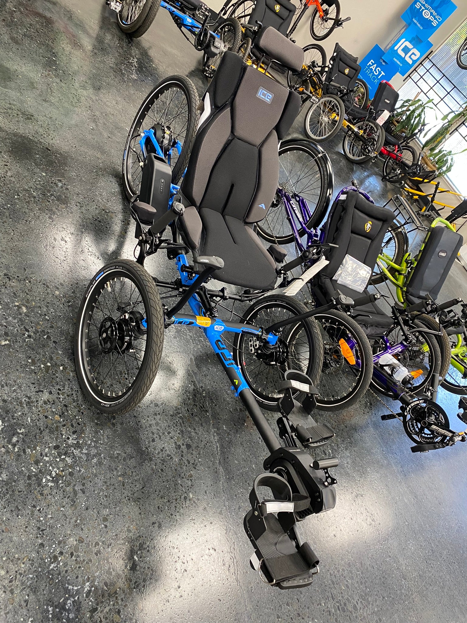 ICE Adventure PERS chainless trike in blue, front three quarter view