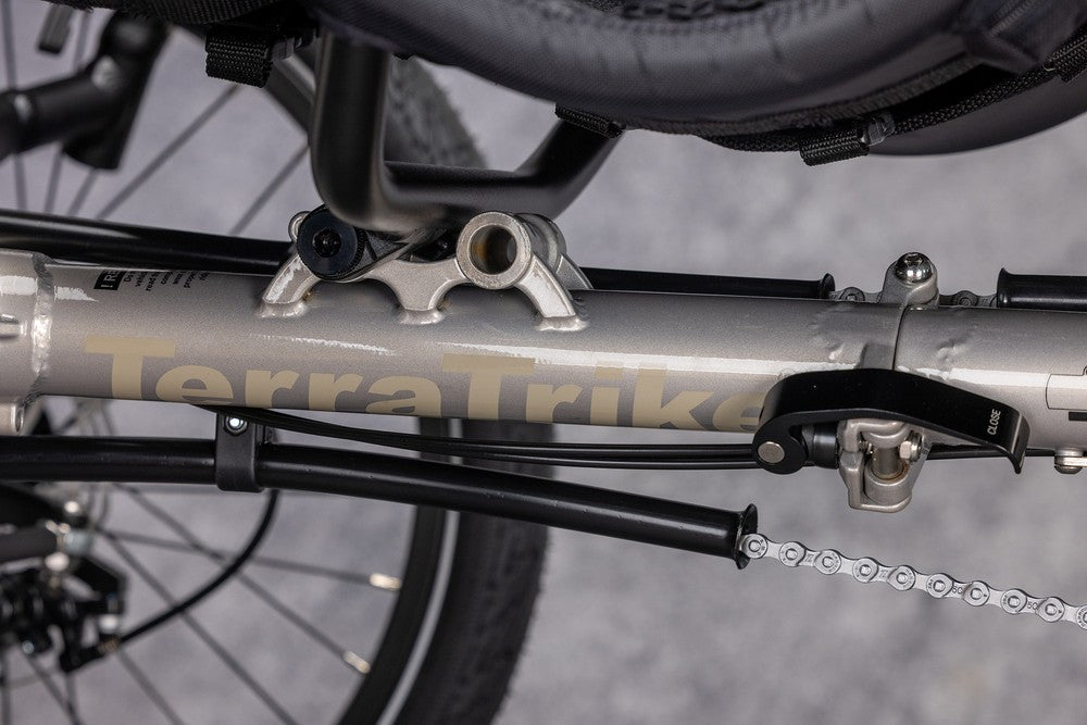 Single fold quick release frame hinge on a Champagne TerraTrike Traveler e+ recumbent trike