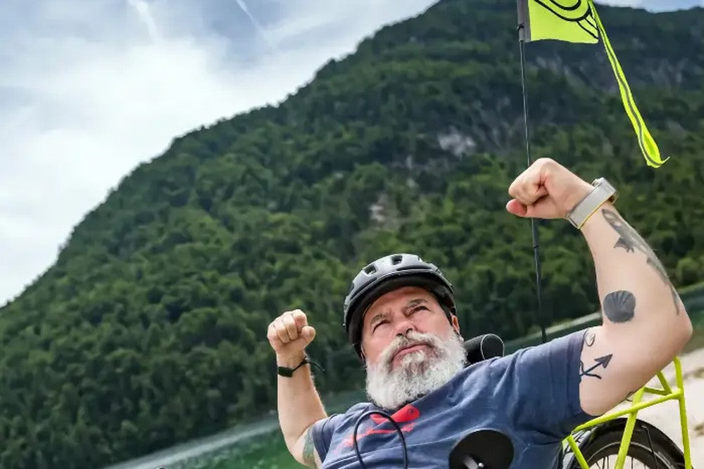 Rider on an AZUB TRIcon GR recumbent trike beside a mountain lake